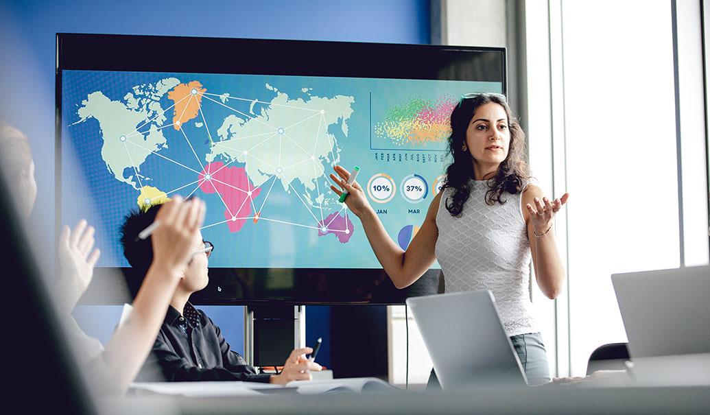 presenting global market data and logistics charts on a large world map display screen