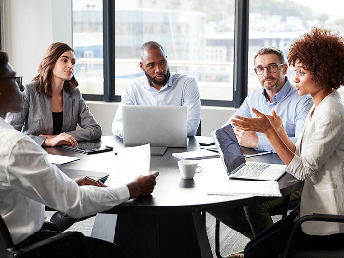 business team collaborating and listening to a colleague speak