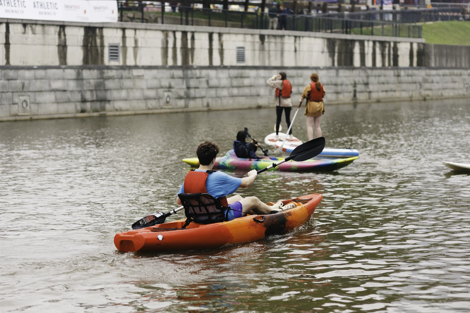 A group of people kayaking on the lake