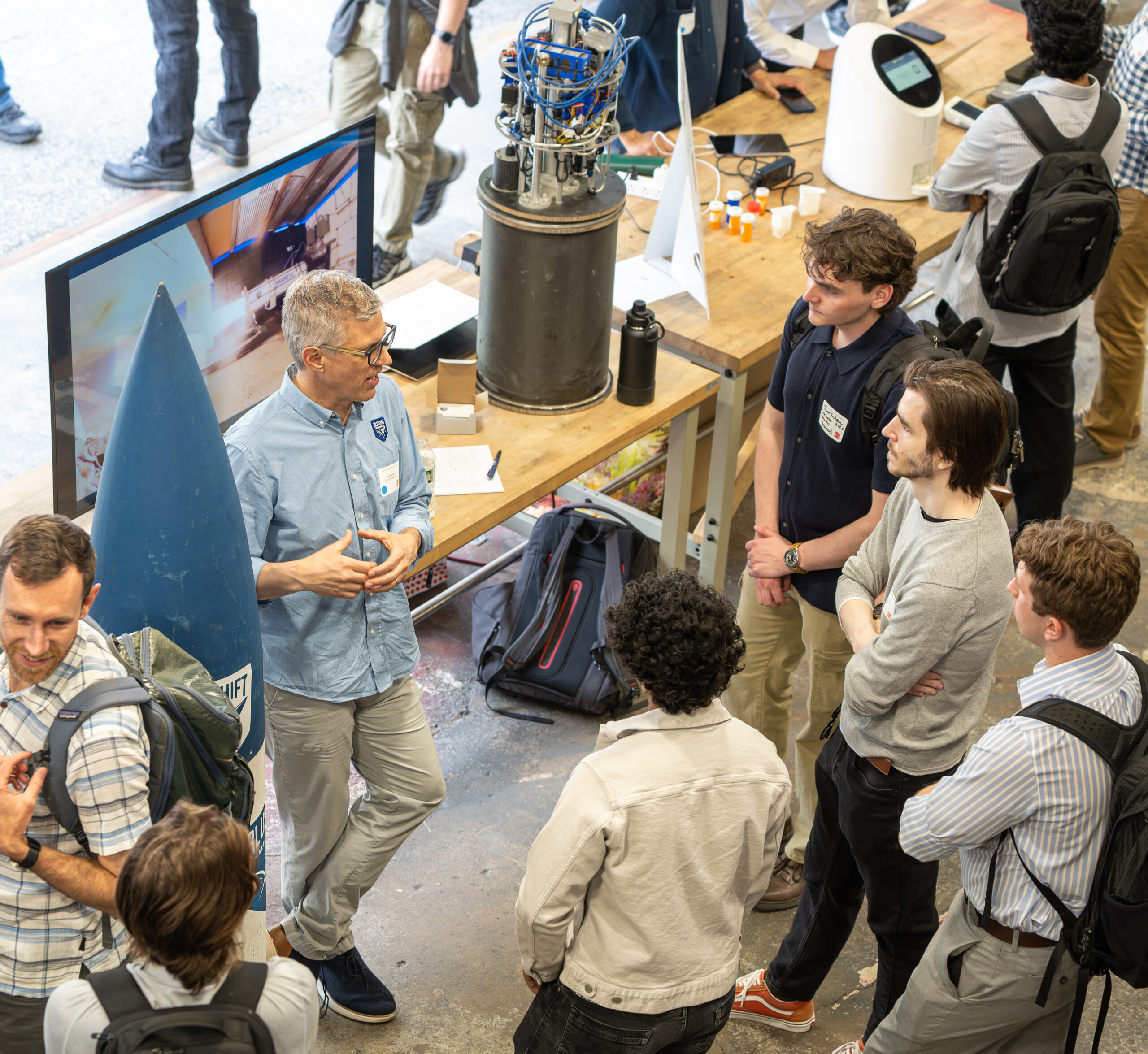 Engineering mentor talking to a group of young students