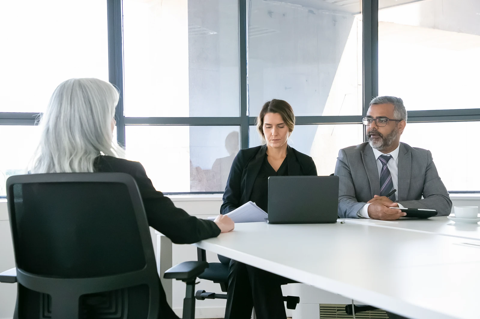 panel interviewing a candidate during a corporate job recruitment meeting