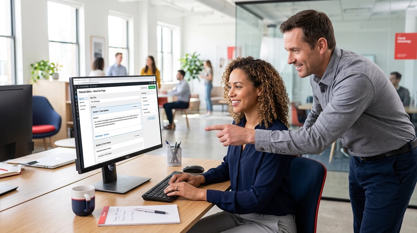 team reviewing a content management system backend and website editor layout on a desktop monitor