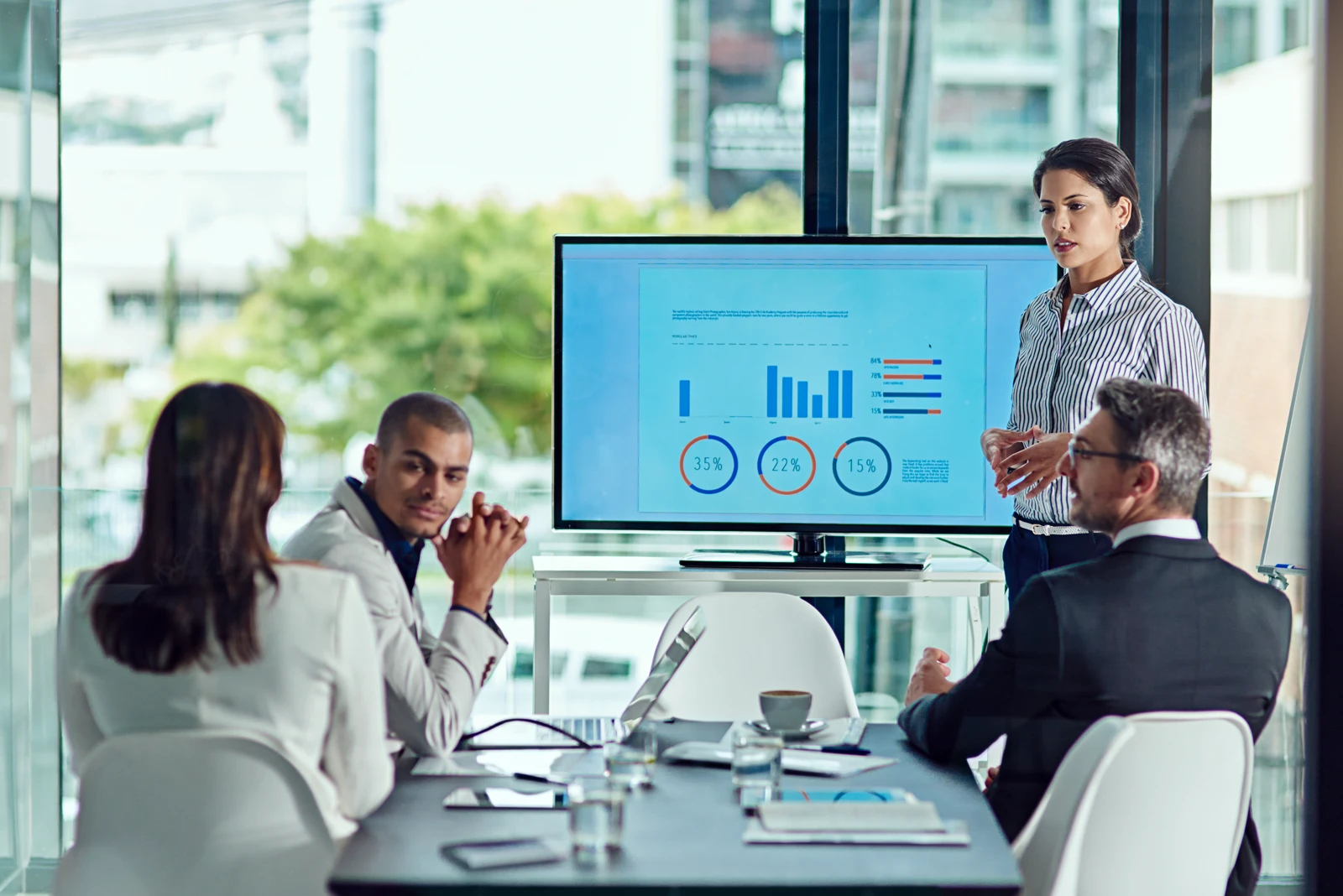 Business presentation showing data insights and growth metrics on a large television display screen during a corporate meeting