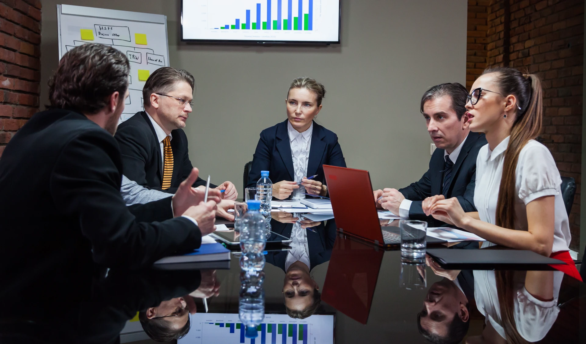 Diverse creative team collaborating on a digital tablet in a modern office space