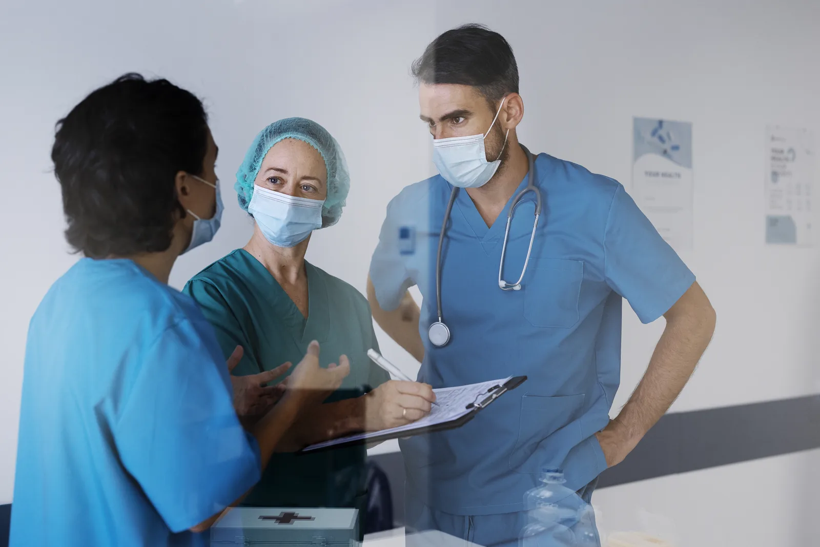 The nurses are talking with the patient